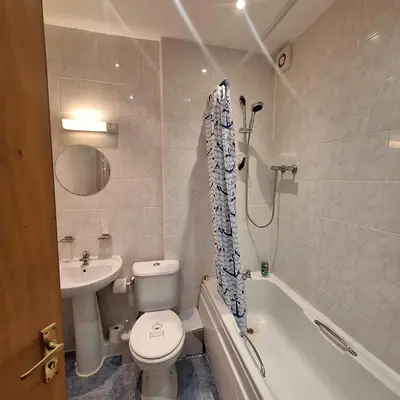 a bathroom with a toilet and a sink and a tub at Spacious 2BR, 5 Min Walk to Anfield, Free Parking in Liverpool