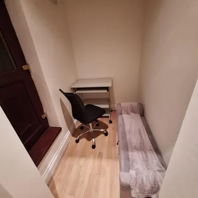 a room with a bed and a desk and a chair at Spacious 2BR, 5 Min Walk to Anfield, Free Parking in Liverpool
