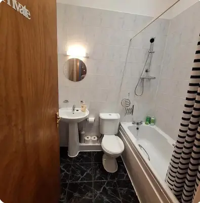 a bathroom with a toilet and a sink and a tub at Spacious 2BR, 5 Min Walk to Anfield, Free Parking in Liverpool