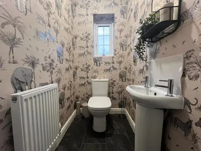 a bathroom with a toilet and a sink at Spring gardens in Lower Darwen