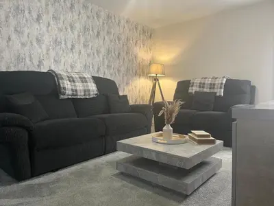 a living room with a couch and a coffee table at Spring gardens in Lower Darwen