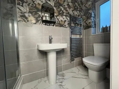 a bathroom with a sink and a toilet at Spring gardens in Lower Darwen