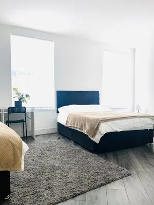 a bedroom with a bed and a rug at Clovelly Road, Anfield LFC in Liverpool
