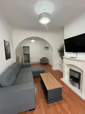 a living room with a couch and a fireplace at 3BR Home, Parking, Families, Contractors, Wi-Fi in Liverpool