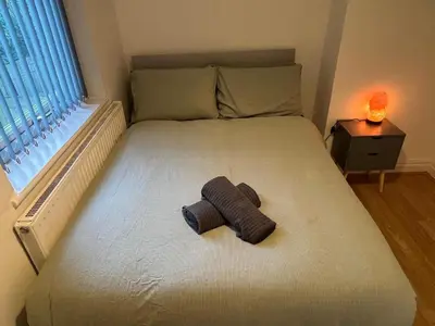 a bed with a roll of yarn sitting on it at 3BR Home, Parking, Families, Contractors, Wi-Fi in Liverpool