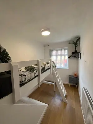 a room with a bunk bed and a staircase at 3BR Home, Parking, Families, Contractors, Wi-Fi in Liverpool