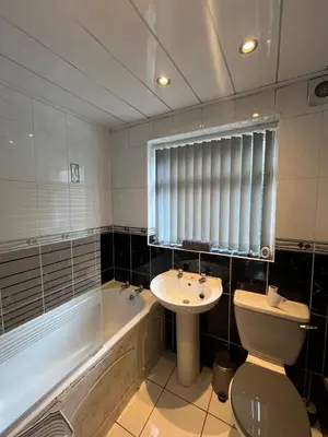 a bathroom with a sink and a toilet and a tub at 3BR Home, Parking, Families, Contractors, Wi-Fi in Liverpool