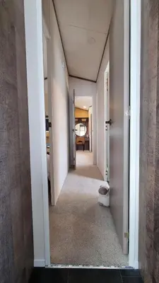a hallway with a hallway leading to a room at 1 Sunset View in Millom