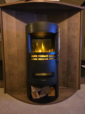 a living room with a fireplace in a room at 1 Sunset View in Millom
