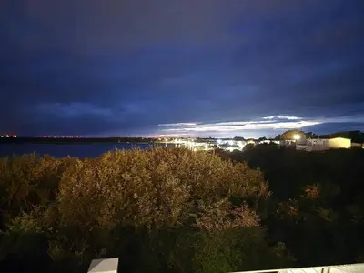 a view of a body of water at night at 1 Sunset View in Millom