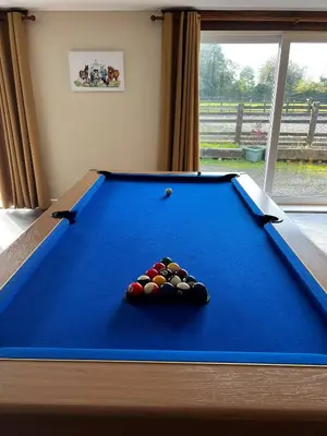 a blue pool table with a pile of balls on it at Charming Retreat with Sauna, Dog Swimming Pool, and Rural Charm in Leyland