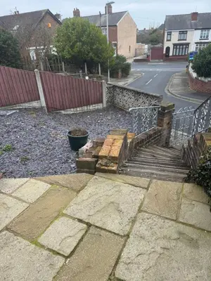 a wooden stairway with a fence and a street at Hillside Stays - Cosy 2 Bed Bungalow, Pet Friendly in Blackpool