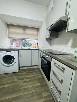 a kitchen with a washing machine and a washer at Hillside Stays - Cosy 2 Bed Bungalow, Pet Friendly in Blackpool