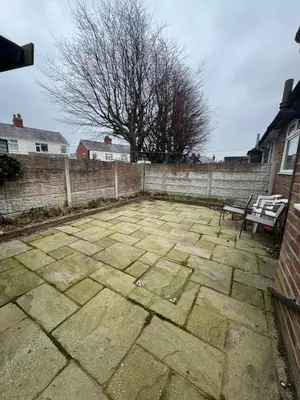 a stone patio with a bench and a fence at Hillside Stays - Cosy 2 Bed Bungalow, Pet Friendly in Blackpool