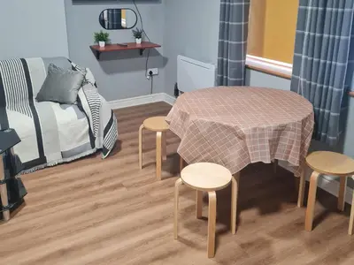 a room with a table and two chairs and a bed at Morcombe Retreat in Morecambe