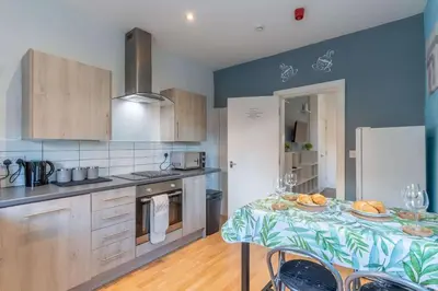 a kitchen with a table with plates of food on it at The Kensington House in Liverpool