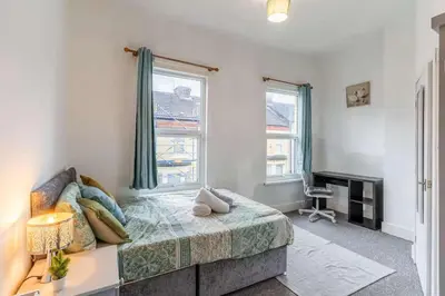 a bedroom with a bed and a window at The Kensington House in Liverpool