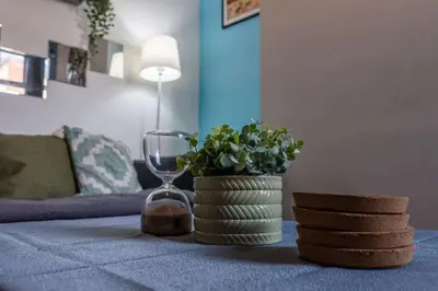 a table with a wine glass and a plant on it at The Kensington House in Liverpool