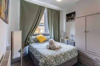 a small bedroom with a bed and a window at The Kensington House in Liverpool