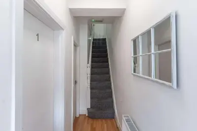 a staircase in a white room with a stair case at The Kensington House in Liverpool