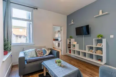 a living room with a couch and a table at The Kensington House in Liverpool