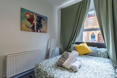 a bedroom with a bed with towels on it at The Kensington House in Liverpool