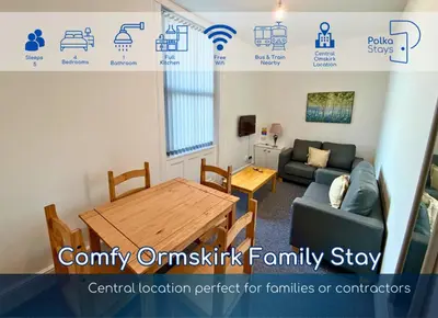 a living room with a table and a couch at Comfy Ormskirk Family Stay by PolkaStays in Ormskirk
