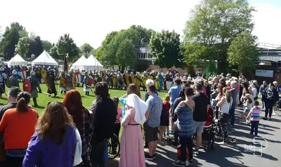 a large crowd of people standing around in a park at Comfy Ormskirk Family Stay by PolkaStays in Ormskirk