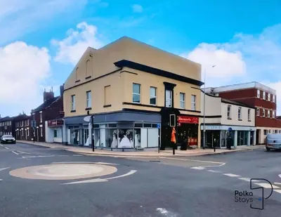 a building on the corner of a city street at Comfy Ormskirk Family Stay by PolkaStays in Ormskirk