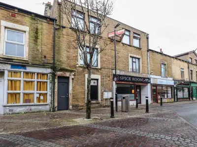 a brick building on the corner of a street at West End Retreat in Morecambe