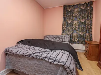 a bedroom with two beds and a window at West End Retreat in Morecambe