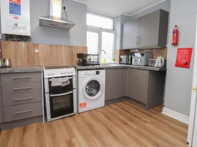 a kitchen with a washing machine and a washer at West End Retreat in Morecambe