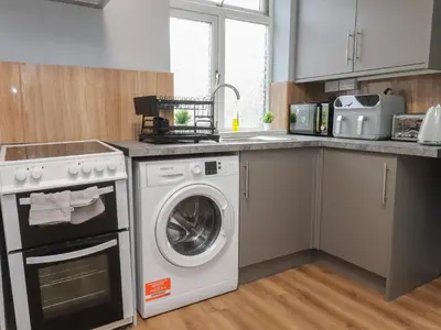 a kitchen with a washer and a dishwasher at West End Retreat in Morecambe