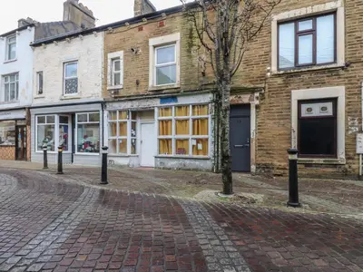 a cobblestone street in front of a building at West End Retreat in Morecambe