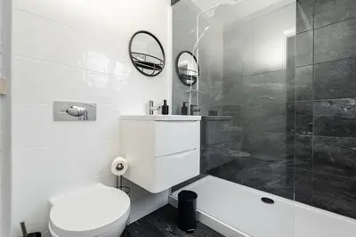 a white bathroom with a toilet and a shower at Cosy Anfield Home in Liverpool