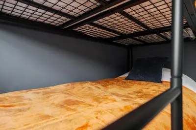 a large wooden bed in a bunk bed at Cosy Anfield Home in Liverpool