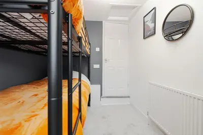a bedroom with a bunk bed and a mirror at Cosy Anfield Home in Liverpool