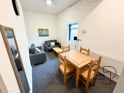a living room with a table and a couch at Sleeps 10 Spacious for Contractors by PolkaStay in Ormskirk