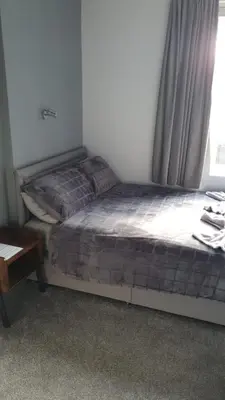 a small bed in a room with a window at The Lenbrook in Blackpool