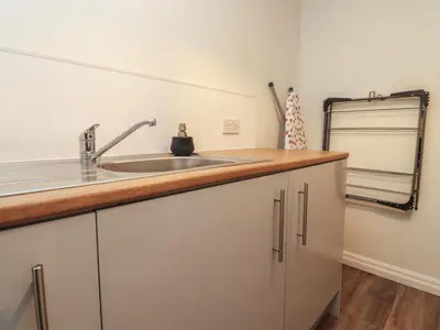 a kitchen with a sink and a counter at Seaside Serenity in Lytham St Annes