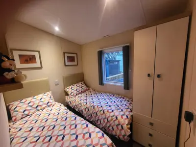 a bedroom with two beds and a window at 47 Venture Caravan Park in Morecambe
