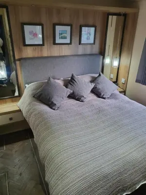 a large bed with pillows in a bedroom at 47 Venture Caravan Park in Morecambe