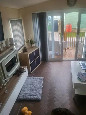 a living room with a television and a fireplace at 47 Venture Caravan Park in Morecambe