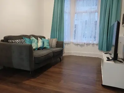 a living room with a couch and a window at Anfield Breaktime House in Liverpool