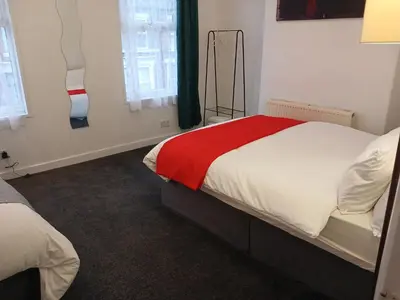 a bedroom with a bed with a red blanket at Anfield Breaktime House in Liverpool