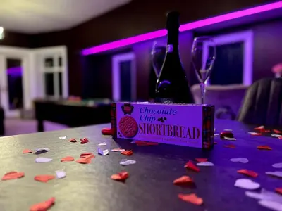 a table with a bottle of wine and confederate city of thunderhead sign at Hamilton Luxury - The James Suite in Scorton