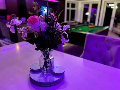 a vase of purple flowers sitting on top of a table at Hamilton Luxury - The James Suite in Scorton