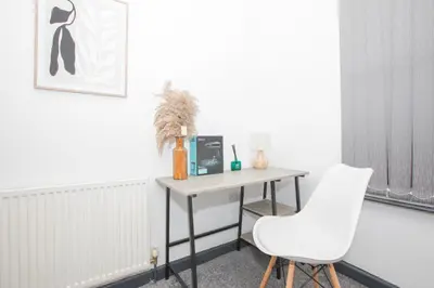a room with a desk and a white chair at Cozy Liverpool Base Close to City Centre in Liverpool