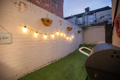 a brick wall with string lights on it at Cozy Liverpool Base Close to City Centre in Liverpool