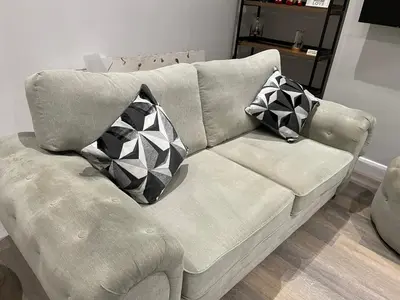 a couch with two pillows on it in a living room at Comfortable 2BR Home in Southport up to 6 guest in Southport